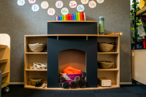 cosy-wooden-early-childhood-fireplace-with-display-space