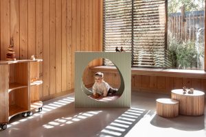 ece-cove-fluted-nook-sage-green-baby-crawling-through-lsg