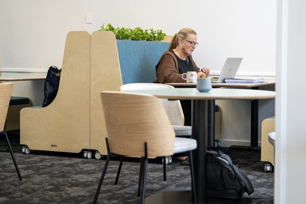dargaville-highschool-staffroom-teacher-sitting-at-booths-with-kaha-tables-and-clive-chairs